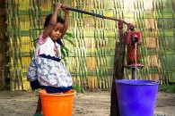 Friday Photo: Small Wonder Travel the World – A child pumps water into a dirty...