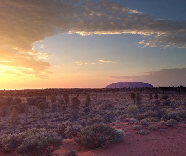 : Early evening as Ayer’s Rock begins its daily transformation of colors.