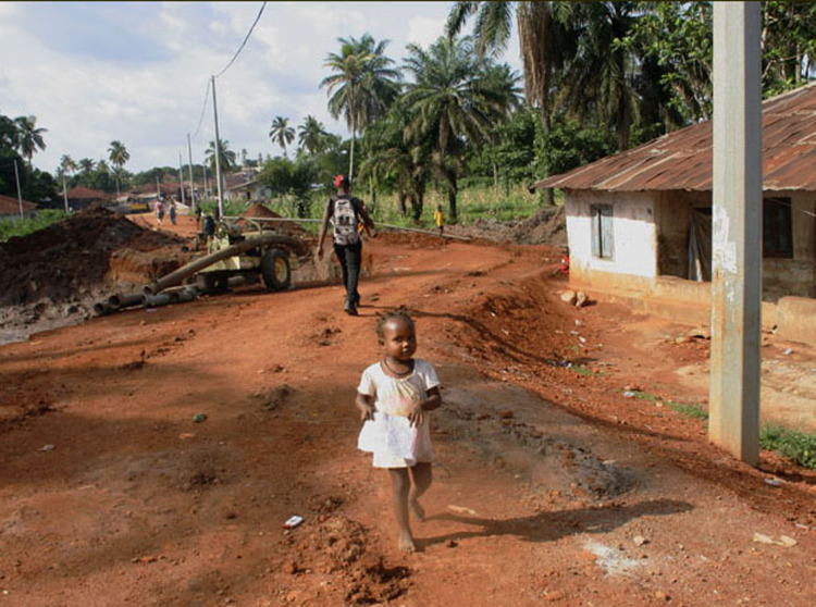 A little girl runs towards me, 'Aporto', in Makeni, a few days before the Sierra Leone Marathon hosted by Street Child of Sierra Leone.